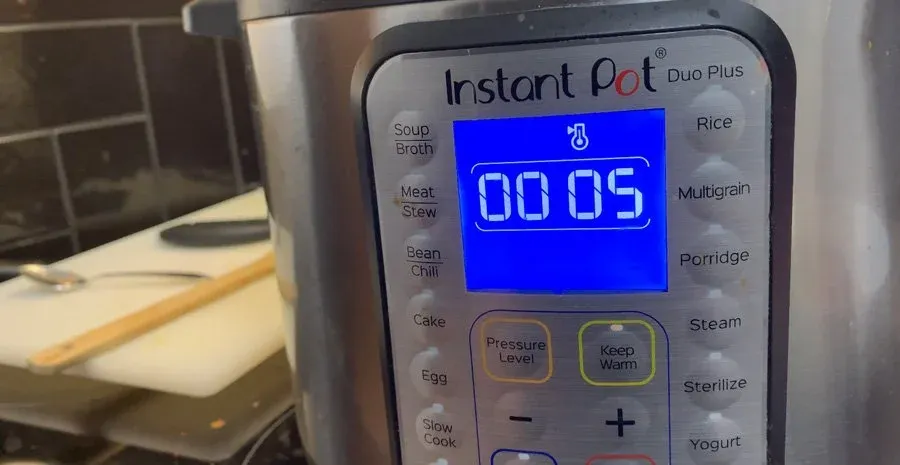 Instant Pot Duo Plus display showing 5 minutes remaining on high pressure cook setting.