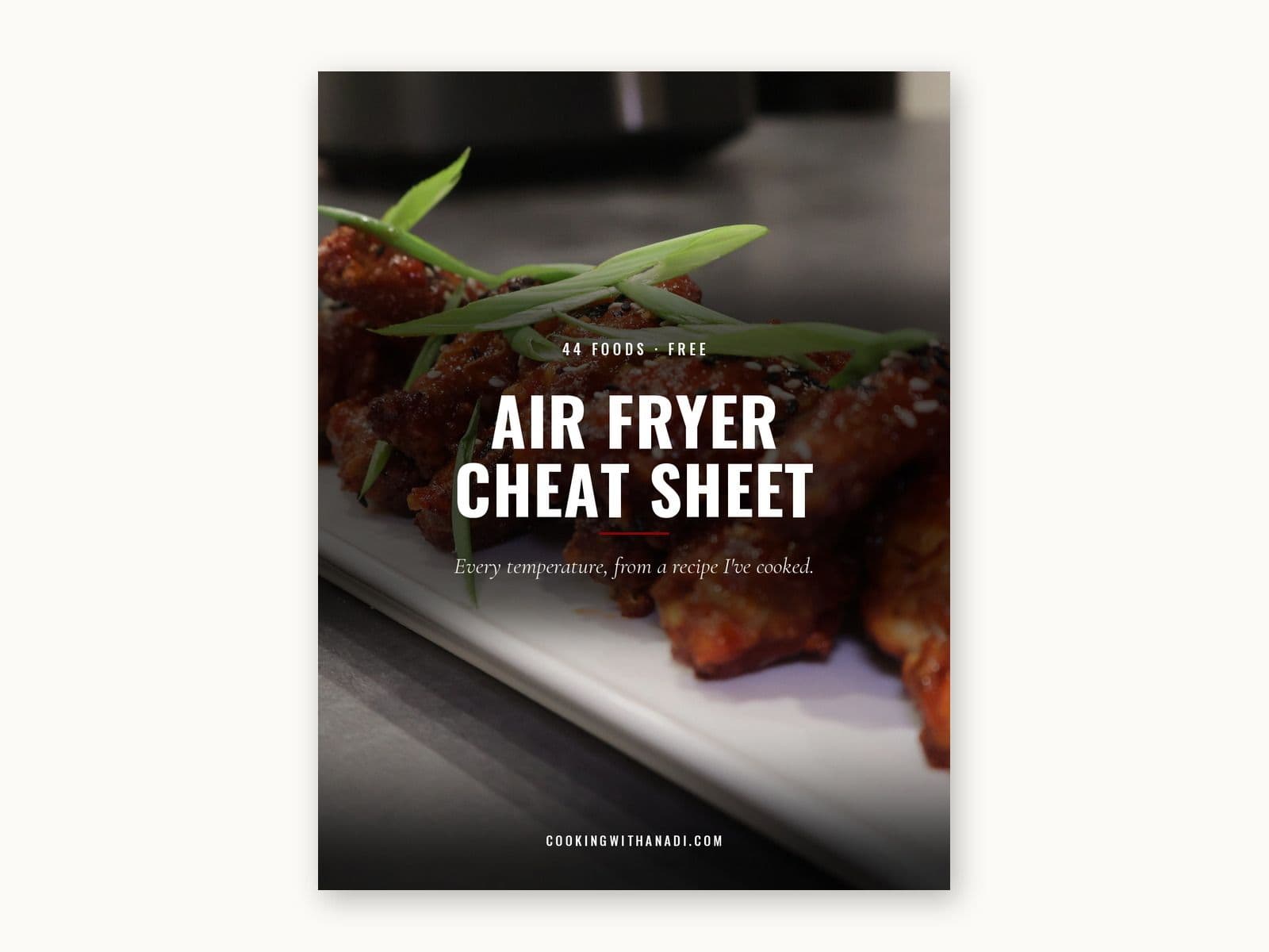 Cover of the Air Fryer Cheat Sheet, over a photograph of glazed Korean fried chicken wings on a white platter.