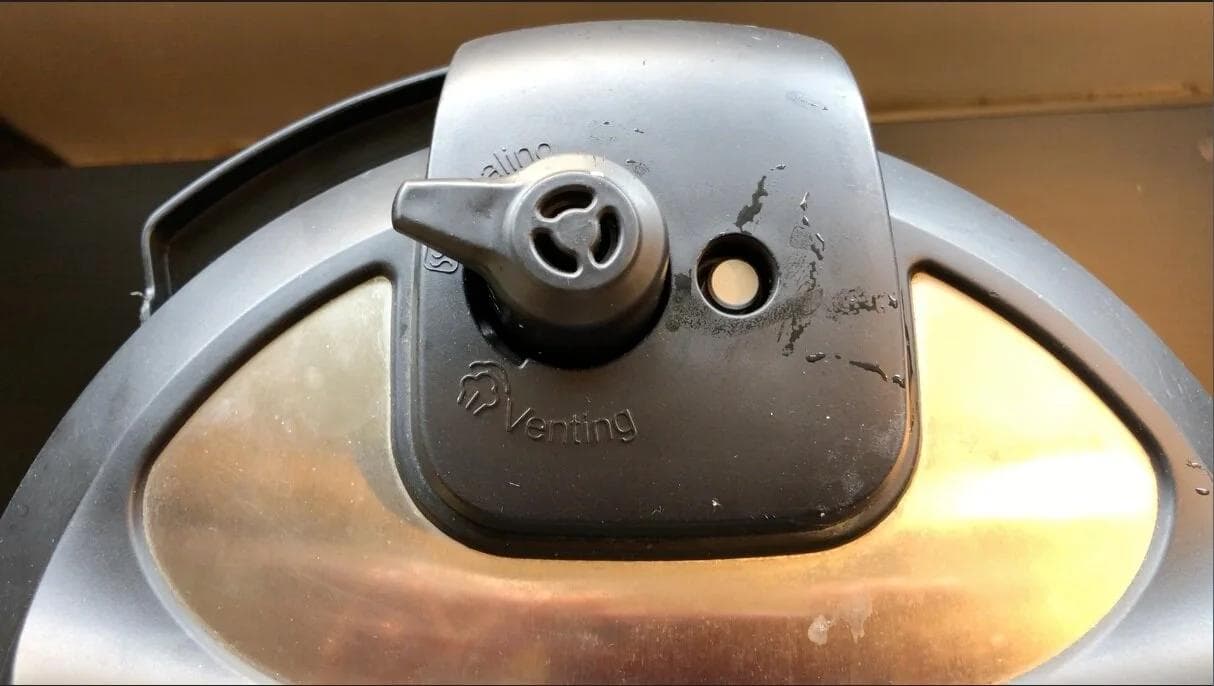 Instant Pot lid closed in sealing mode with valve set to seal for pressure cooking potatoes.