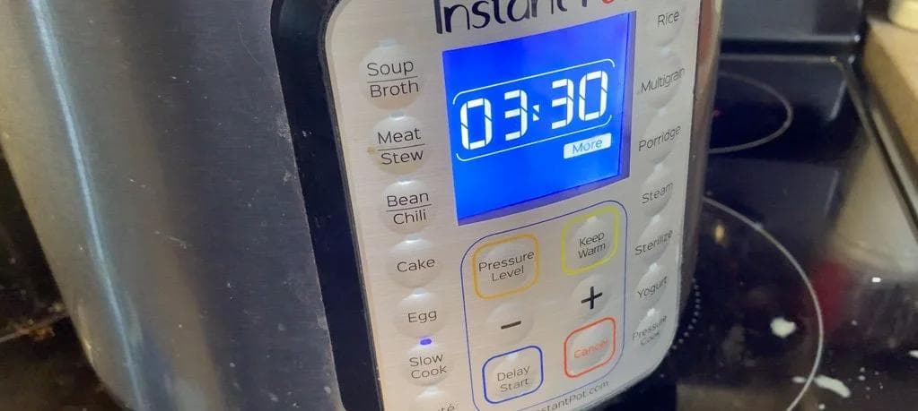 Instant Pot set to Slow Cook mode displaying 03:30 cooking time on its digital screen.