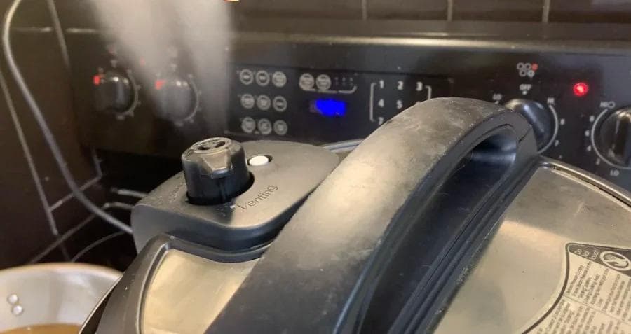 Instant Pot lid with pressure knob turned to Venting mode for quick steam release.