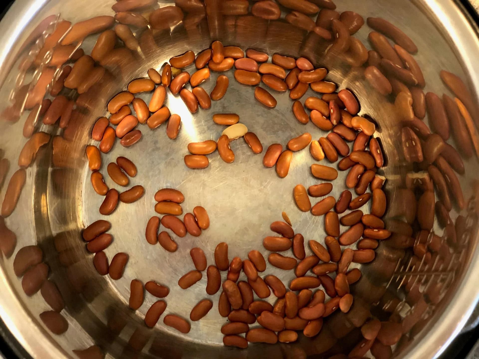Dried red beans rinsed and soaking in water in an Instant Pot inner pot.