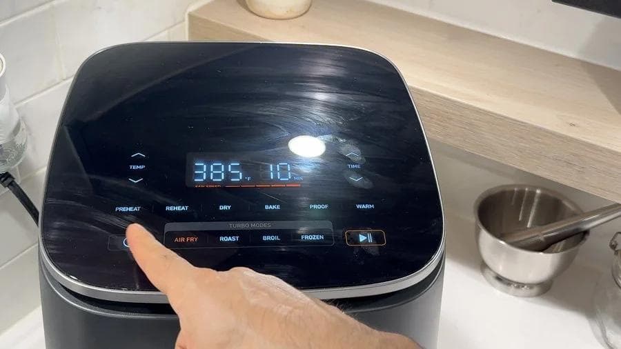 Air fryer display showing 385°F temperature set for cooking twice baked potatoes with cheese topping.