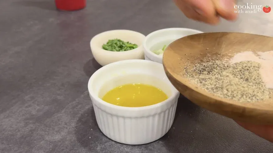 Mise en place for smashed potatoes: bowls of melted butter, green onions, and salt and pepper, with a wooden bowl of seasoning mix.