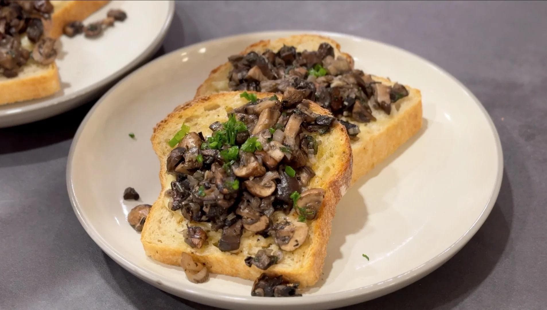 Hearty mixed mushrooms and caramelized onions piled on toasted bread, garnished with fresh green onions.