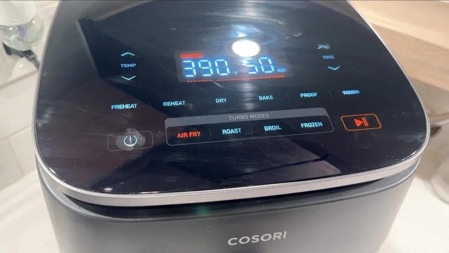 Cosori air fryer displaying 390°F temperature setting for cooking potatoes.