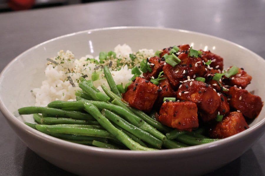Crispy air fryer Korean tofu bowl with gochujang sauce, green beans, and sesame rice