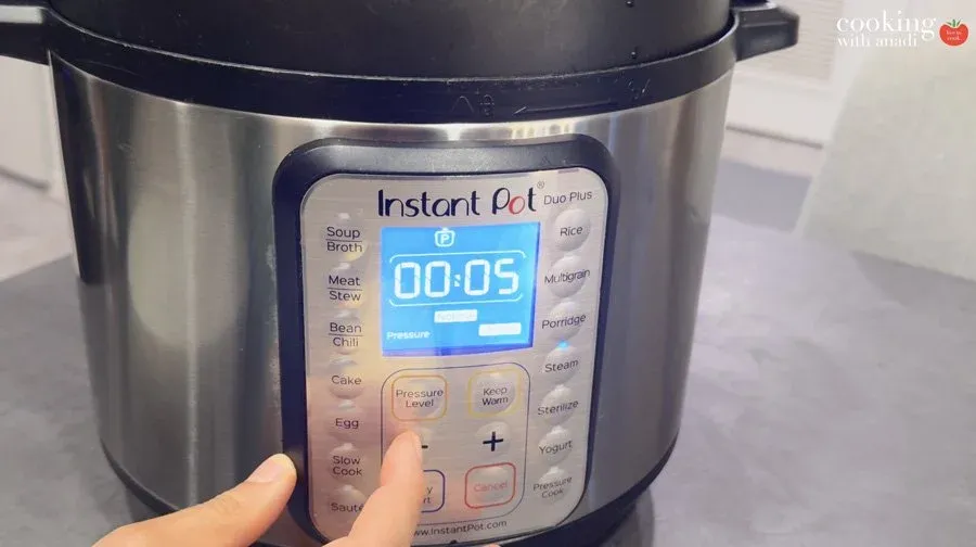 Instant Pot Duo Plus displaying 00:05 timer on display screen for steaming potatoes.