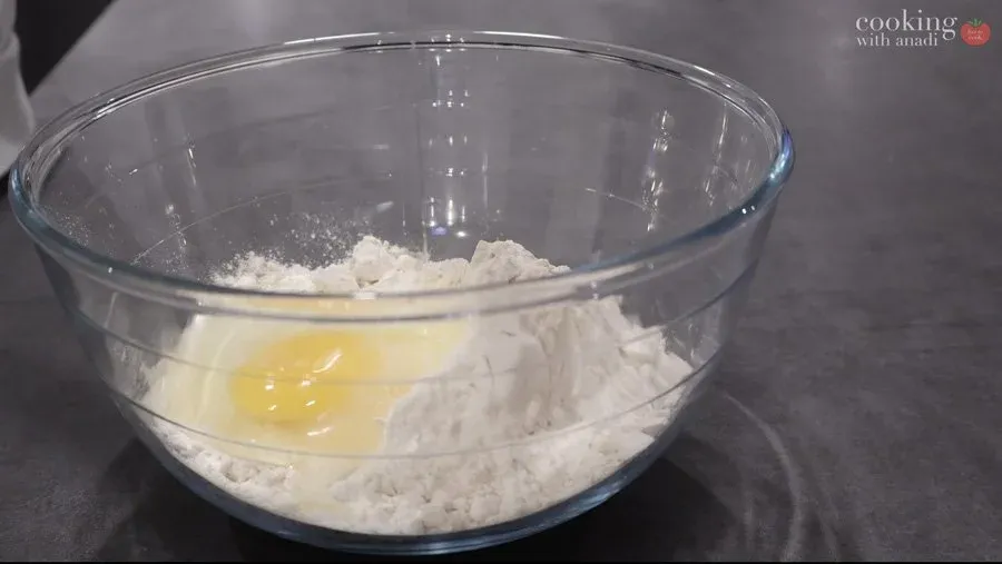 Gluten-free flour and salt mixed in a bowl with egg and melted butter ready to combine into dough.
