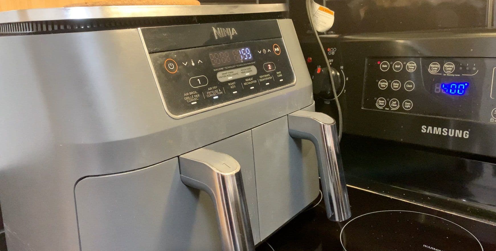 Ninja air fryer set to 390°F next to a Samsung microwave on a kitchen counter.