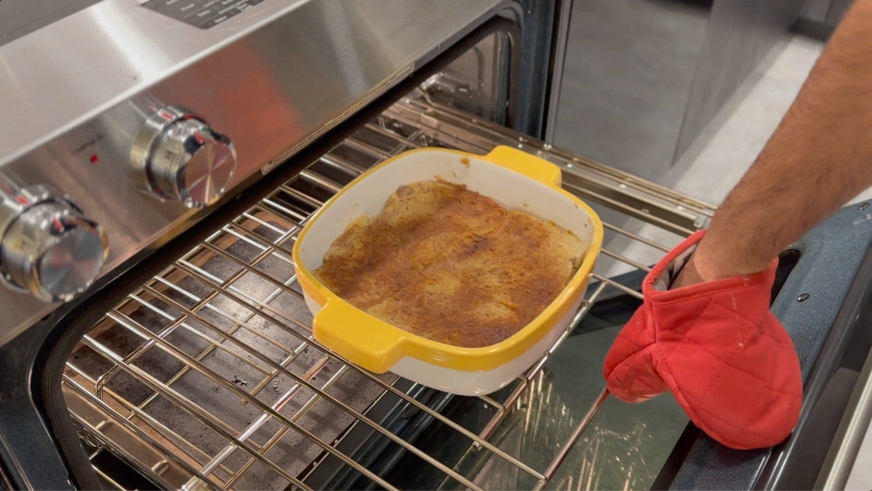 French toast casserole with cinnamon sugar topping baking in oven on middle rack.