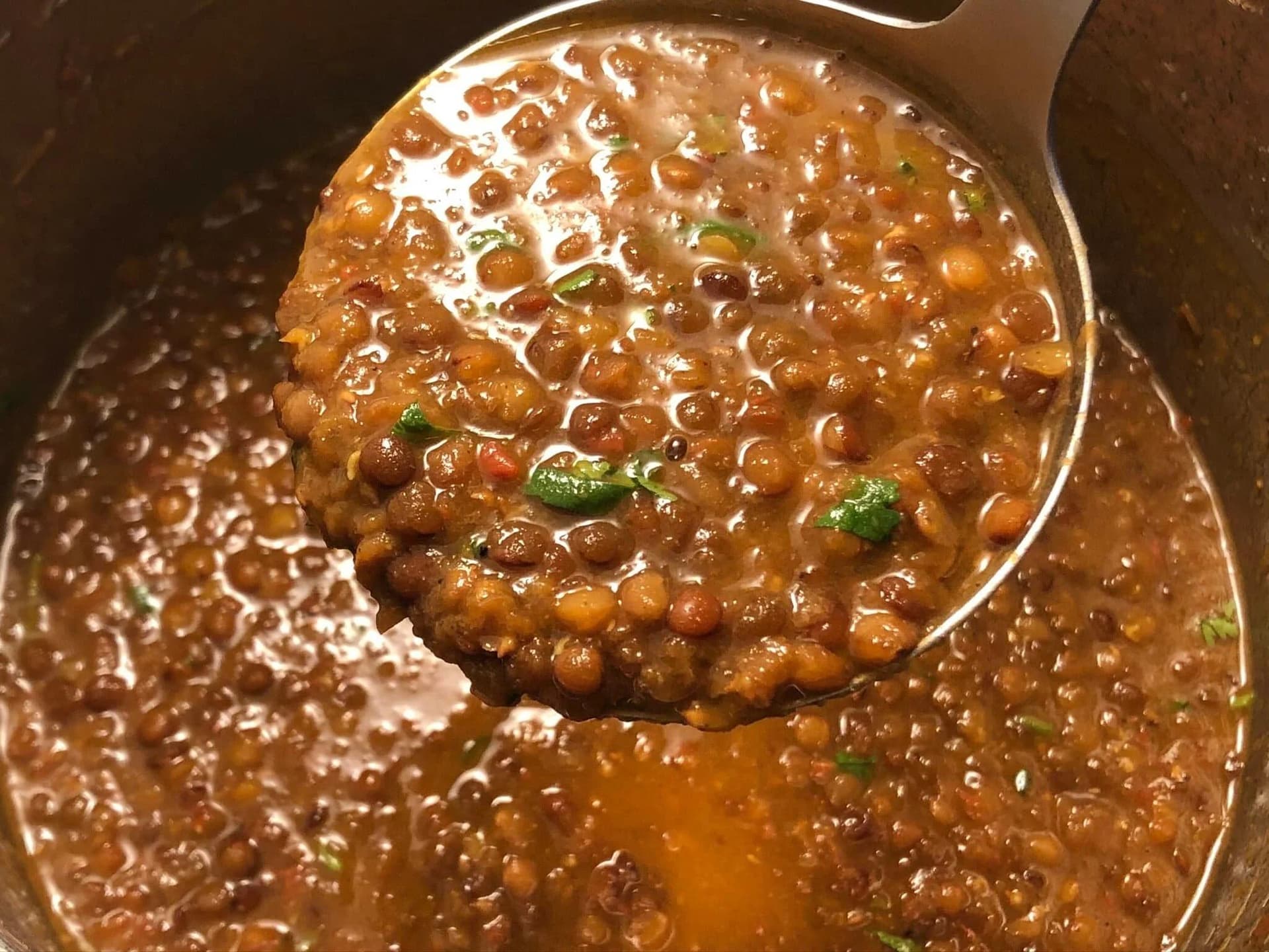 Cooked masoor dal with fresh cilantro garnish in an Instant Pot, ready to serve.