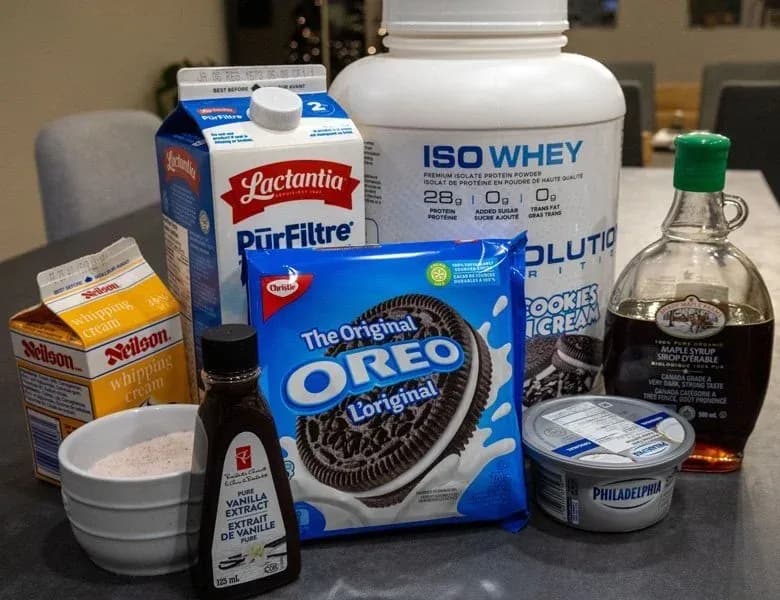 Ingredients for high protein Oreo McFlurry including Oreo cookies, whey protein powder, cream cheese, milk, vanilla extract, and maple syrup.