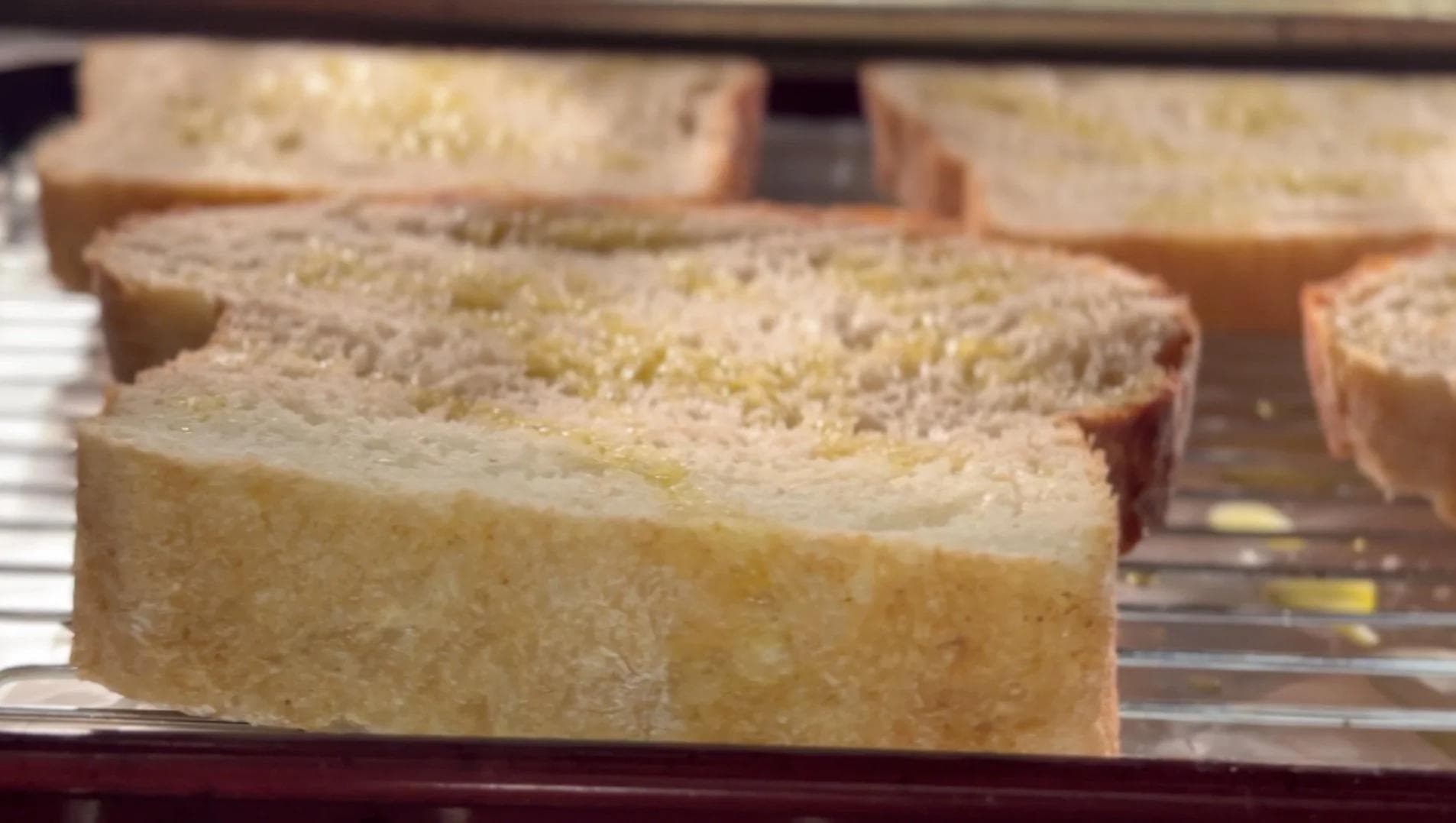 Golden toasted sourdough bread slices on a wire rack, ready for mushroom topping.