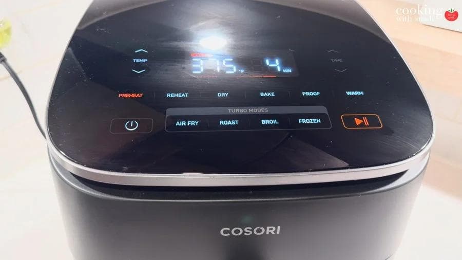 Cosori air fryer control panel set to 375°F with PREHEAT mode illuminated in red