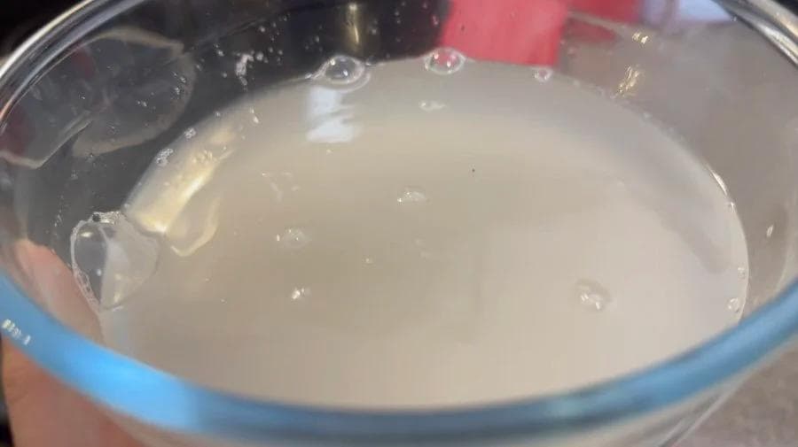 Rinsed rice and water in a pot ready to be brought to a boil for cooking.