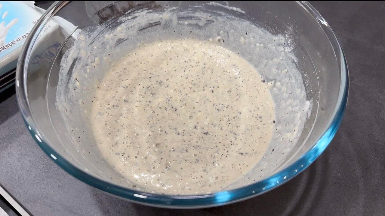 Thick pancake batter with crushed Oreos mixed in, ready to be cooked in a glass bowl.