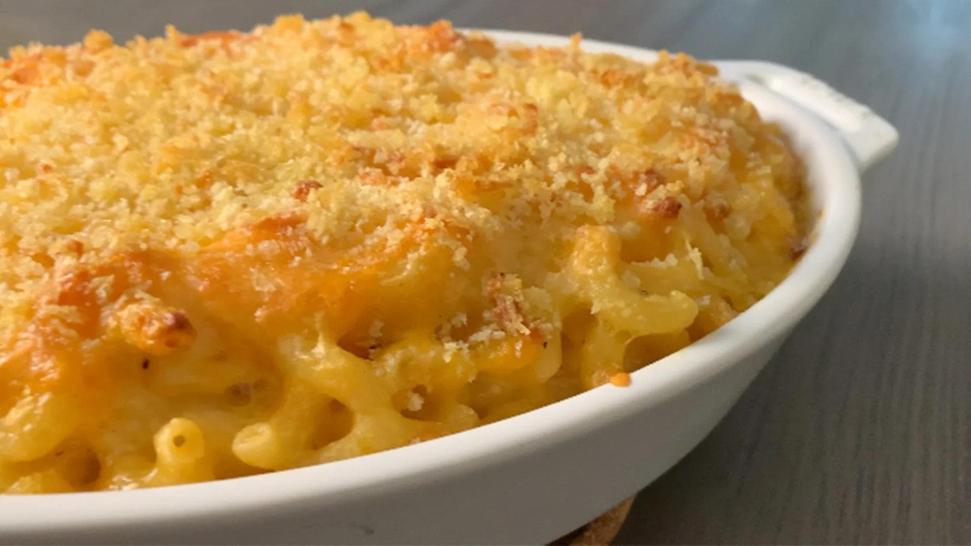 Baked mac and cheese with golden breadcrumb topping in a white dish