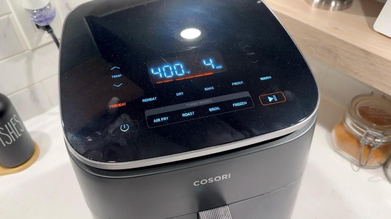 Cosori air fryer displaying 400°F on digital display screen during preheat stage.