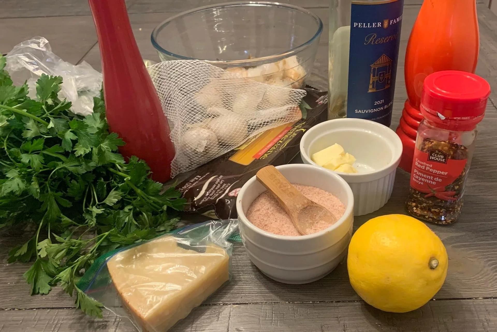 Ingredients for white wine lemon garlic shrimp scampi: shrimp, pasta, fresh parsley, lemon, butter, garlic, and seasonings.