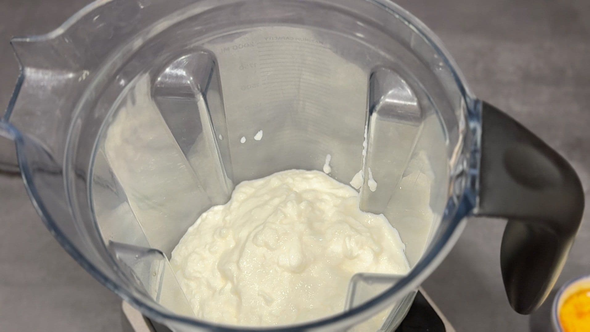 Blended yogurt mixture in food processor for saffron pistachio lassi
