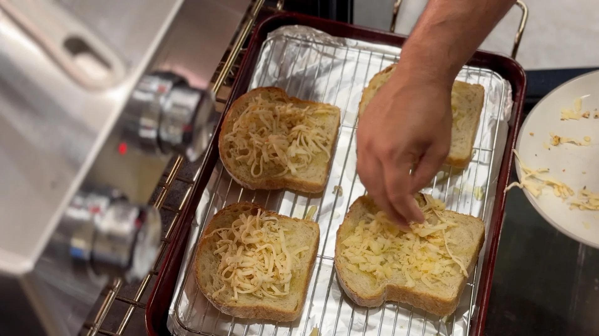 Cheesy toasted sourdough slices on a baking sheet being prepared for mushroom topping.