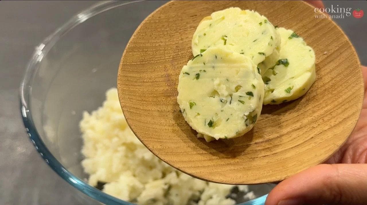 Mashed potatoes with garlic chive butter, green onions, and chives being prepared for twice-baked potatoes.