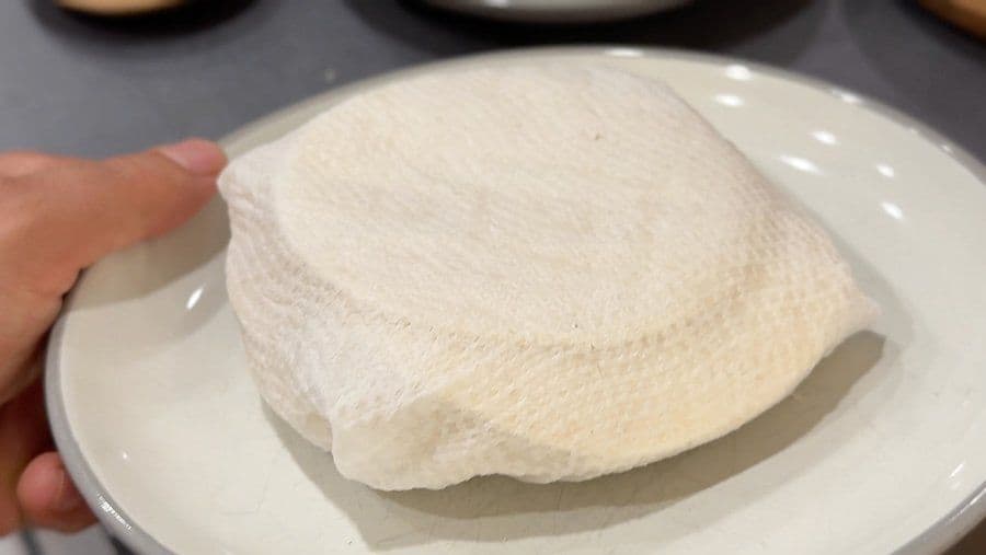 Warm corn tortilla pressed into a muffin cup to form an egg cup shell