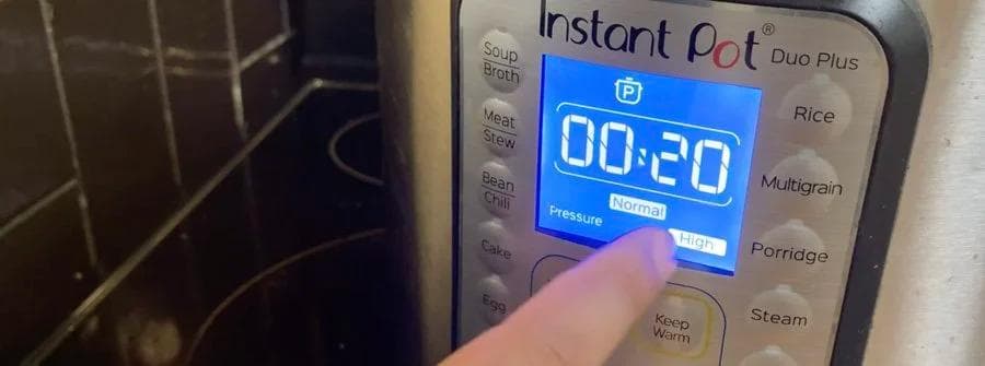 Instant Pot Duo Plus display showing 00:20 high pressure cooking time for dried beans.