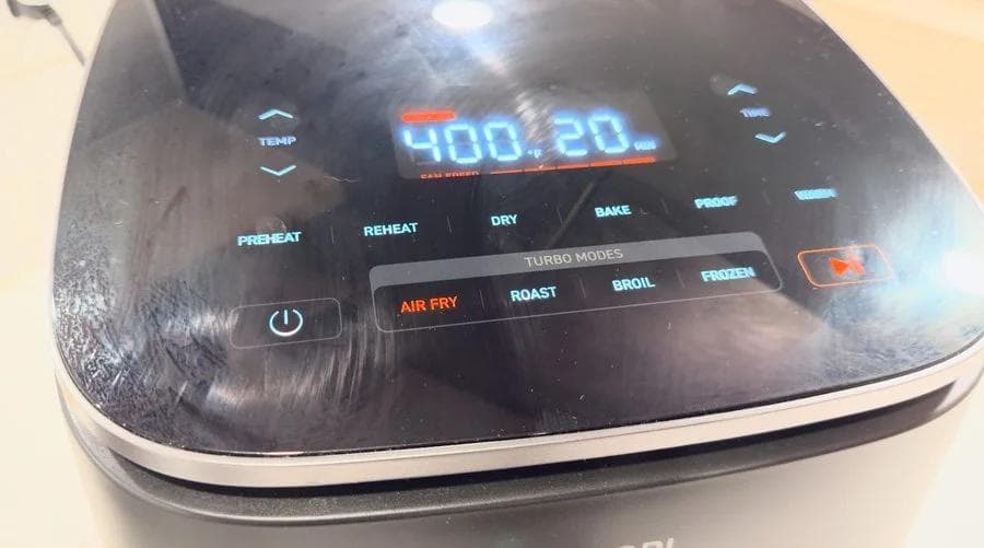 Digital air fryer display showing 400.20°F temperature setting with cooking mode options visible on screen.