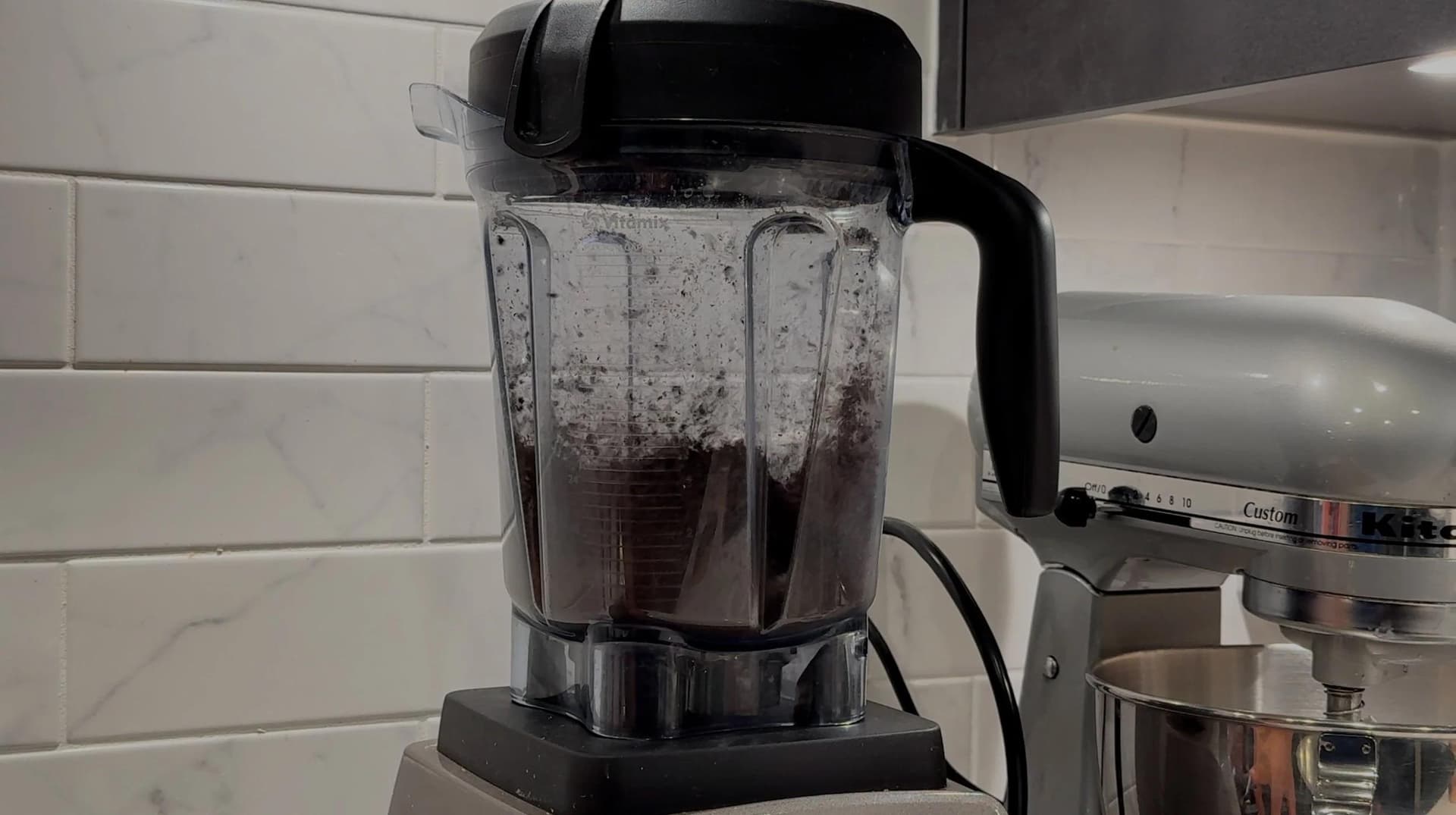 Food processor filled with ground coffee beans for cold brew preparation.