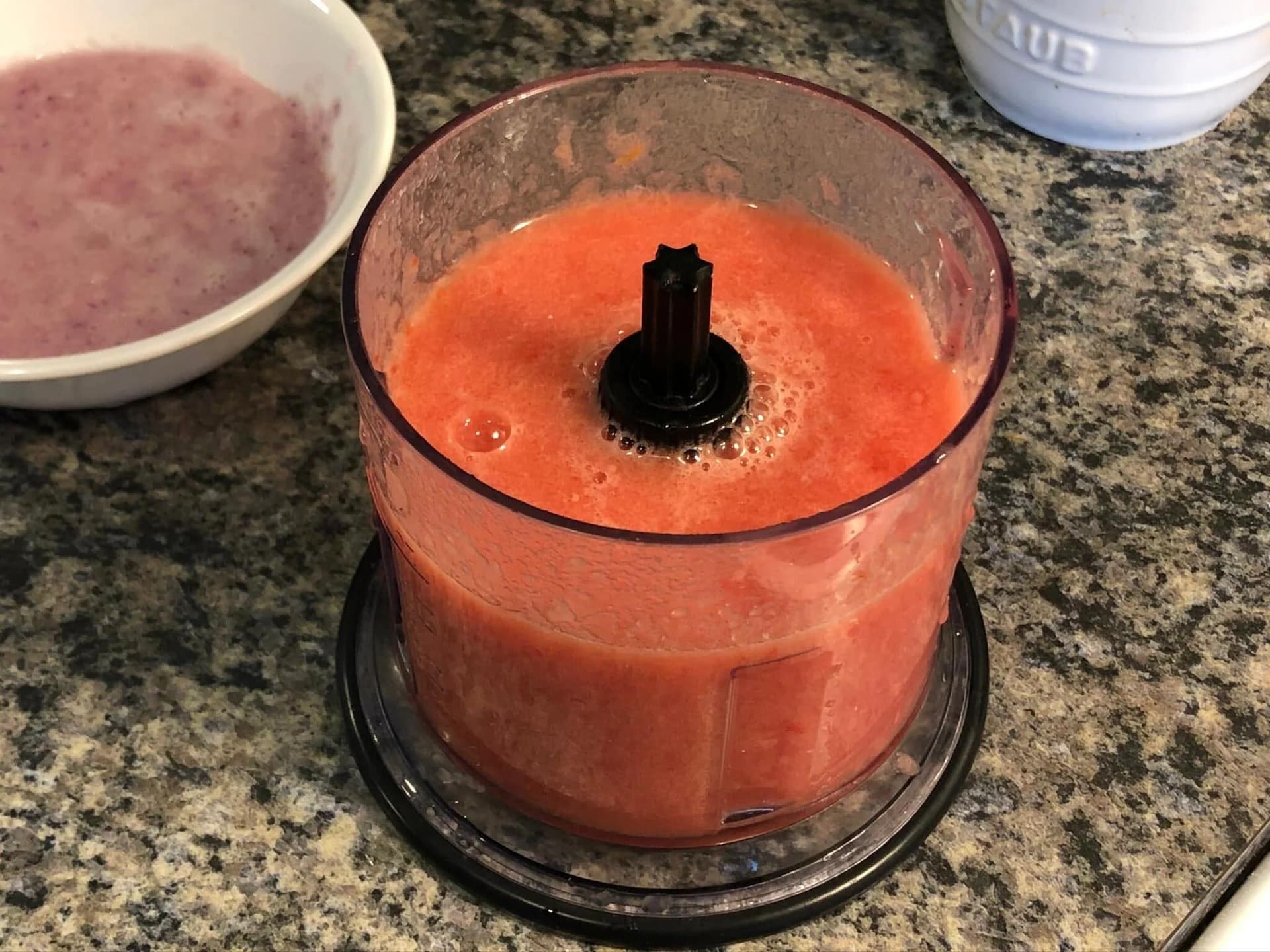 Red tomato puree blended smooth in a food processor, ready for masoor dal recipe.