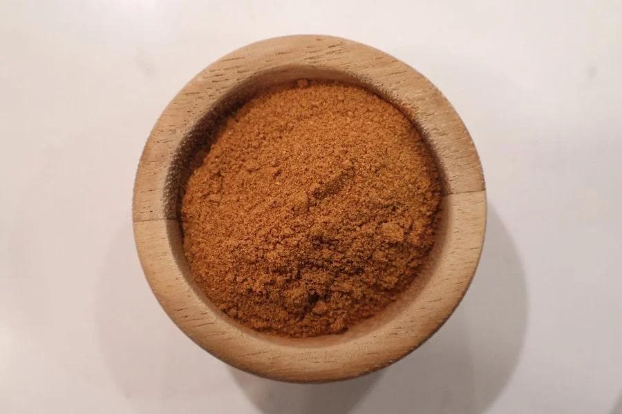 Homemade pumpkin pie spice blend in a wooden bowl