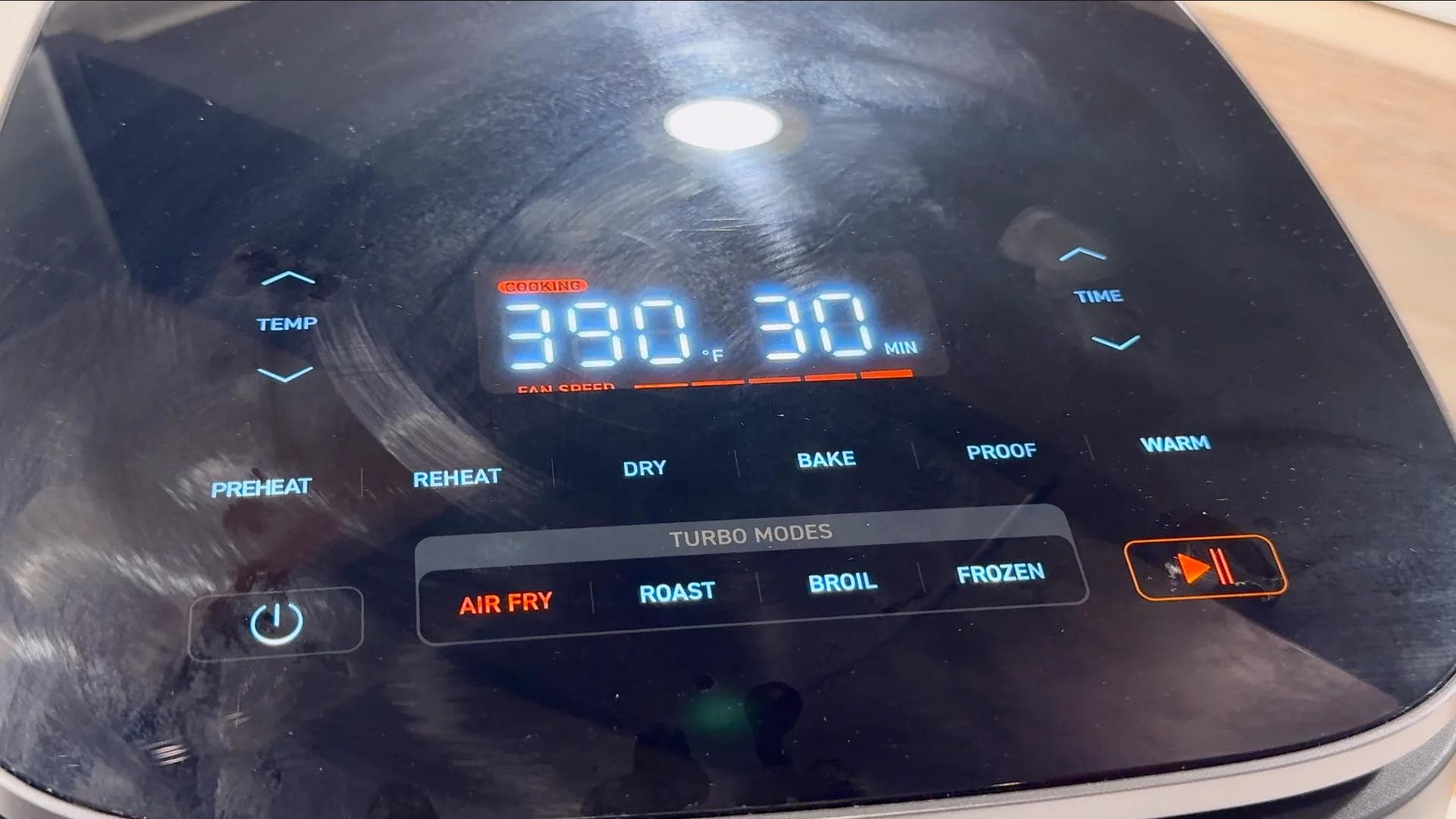 Air fryer display showing 390°F temperature and 30 minutes cooking time set for air fry mode.