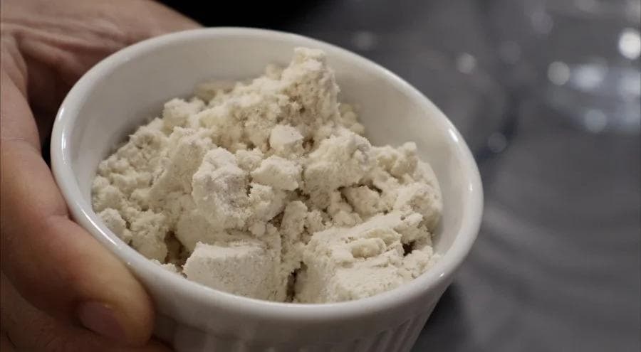 Dry ingredients mixed in white bowl: oat flour, pumpkin spice, protein powder, baking powder and salt.