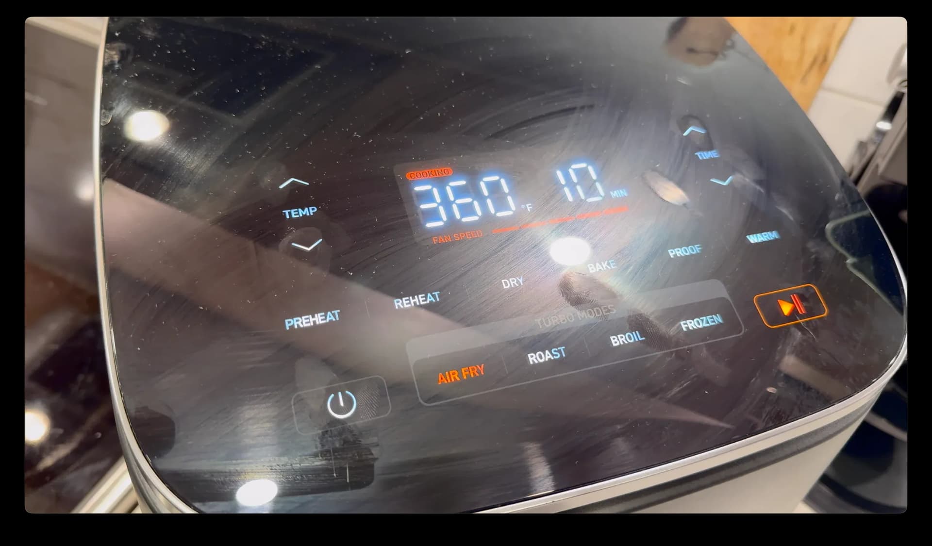 Air fryer display showing 360°F temperature during chicken cooking process